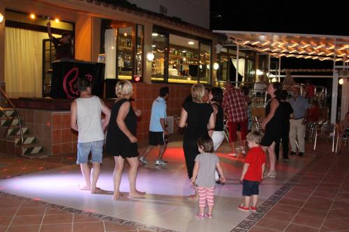 a group of people standing on a dance floor at Hotel Univers in Roses