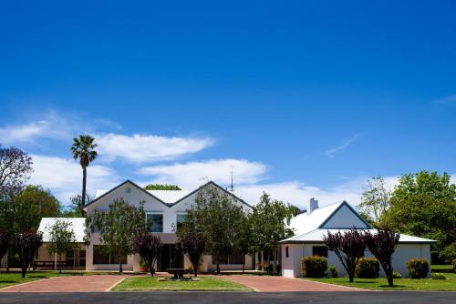 a row of houses on a street with a palm tree at Fairlawn Estate in Busselton