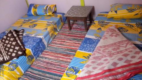 two beds sitting next to each other in a room at SakraTah Camp - eco friendly in Taba