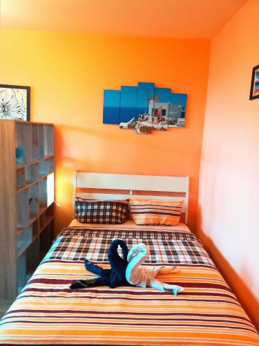 a child laying on a bed in a bedroom at Business Park Apartment in Sofia