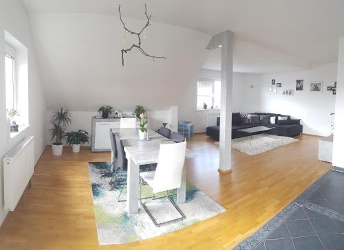 a living room with a table and a couch at Vila na Skalce in Česká Kamenice