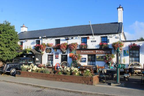 a white building with flowers in front of it at The Nook County Dublin in Dublin