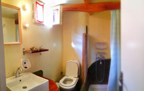 a small bathroom with a toilet and a sink at Trocolo Apartments in Sivota