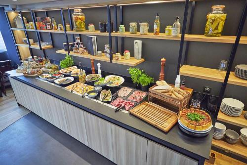 a buffet line with many different types of food at Radisson Hotel Paris Le Bourget in Le Bourget
