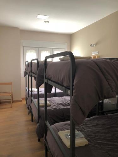 a row of bunk beds in a room at Albergue Camiño Real in Sigüeiro