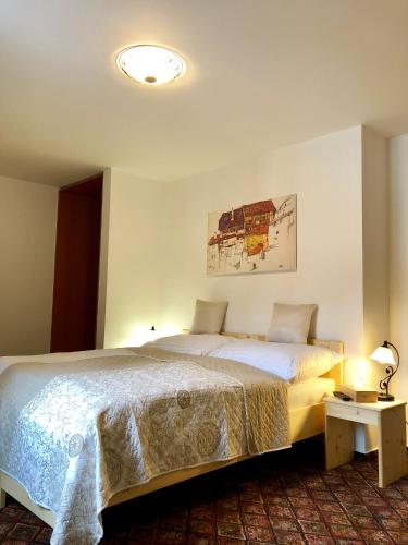 a hotel room with two beds and a lamp at Familia in Český Krumlov