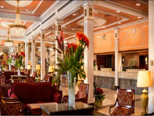 a lobby of a hotel with tables and chairs at Concorde El Salam Cairo Hotel & Casino in Cairo