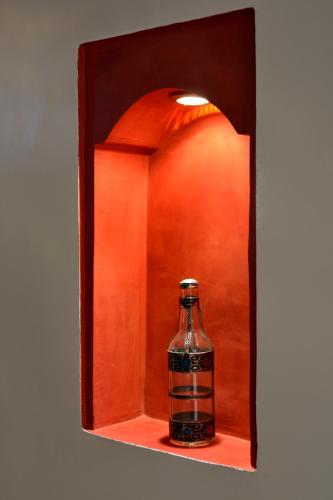 a bottle sitting on a shelf in a box at Dar Yasser in Marrakech