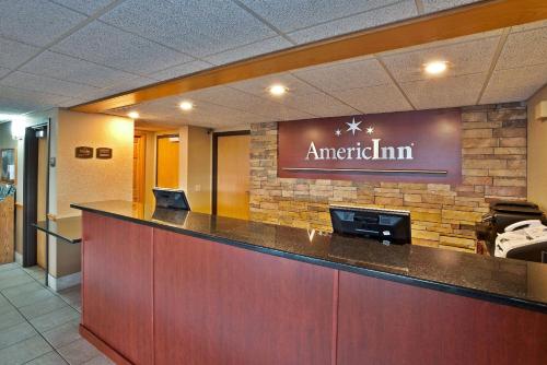 a sign for an american inn on a wall at AmericInn by Wyndham Bay City in Bay City