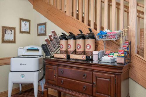 a room with a counter with a staircase and a desk with aitamin at AmericInn by Wyndham Newton in Newton