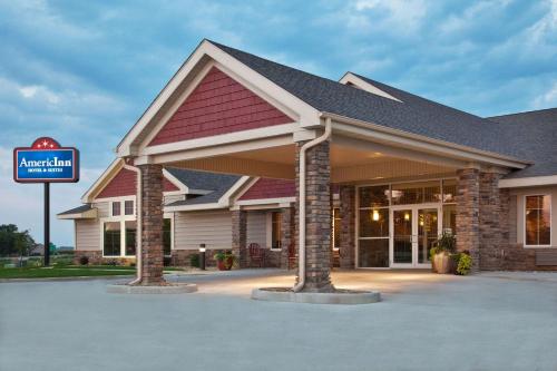 a building with a sign in front of it at AmericInn by Wyndham Osage in Osage