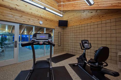 a room with a gym with a treadmill at AmericInn by Wyndham Newton in Newton