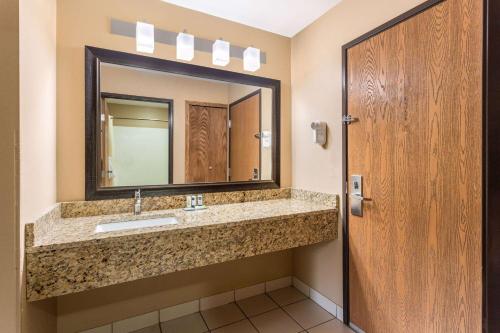 a bathroom with a sink and a mirror at AmericInn by Wyndham Boscobel in Boscobel