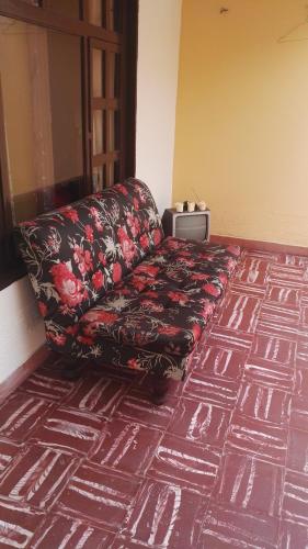 a couch sitting in a room with a carpet at La posada del lago in Aquitania