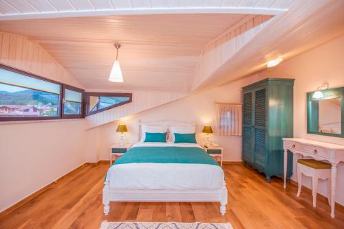 a bedroom with a bed and a desk at Villa TN - Fethiye in Fethiye