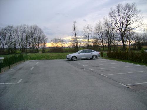 a white car parked in a parking lot at Guest Accomodation Škerlak in Moravske Toplice