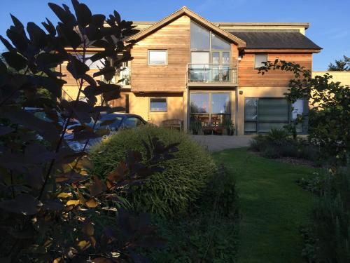 a house with a large window and a yard at Warborough B&B in Wallingford