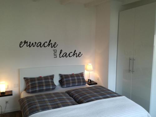 a bedroom with a bed with a sign on the wall at Zimmer zum Hof in Herdecke