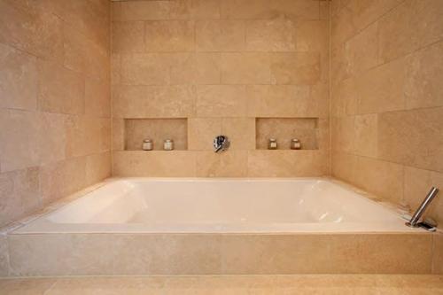 a large white bath tub in a bathroom at Warborough B&B in Wallingford