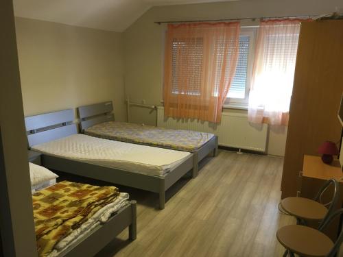 レーヴフュロップにあるMatrózのベッドルーム1室(ベッド2台、テーブル、椅子付)