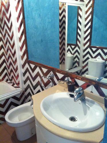 a bathroom with a sink and a toilet and a mirror at Sun and Beach Spain 1B in Nerja