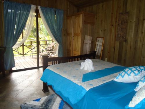 ein Schlafzimmer mit einem Bett mit einem ausgestopften Tier darauf in der Unterkunft J and H Garden Cabinas in Bocas del Toro