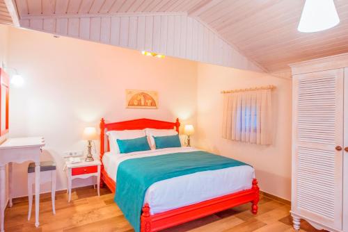 a bedroom with a bed with a red headboard at Villa TN - Fethiye in Fethiye