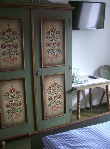 a room with a wall with three pictures on it at Hotel-Restaurant Burg-Ramstein in Kordel