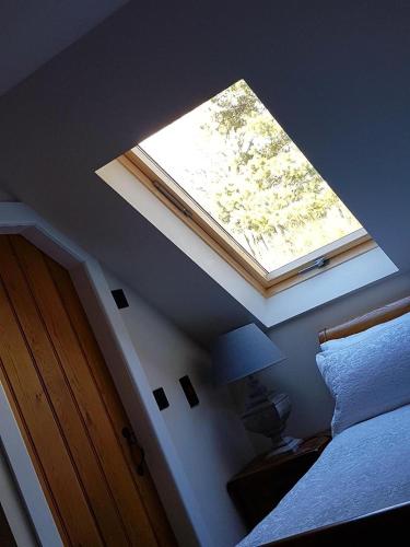 a window in a bedroom with a bed and a lamp at Station House Lanark Bed and Breakfast in Lanark