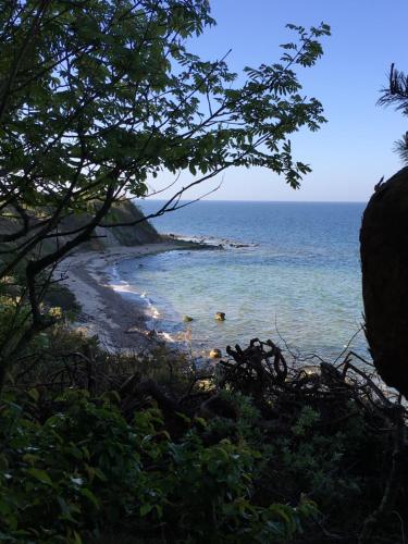 a view of the beach from a bluff at Grønbechs Hotel in Allinge