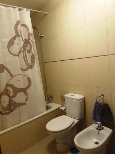 a bathroom with a toilet with a monkey shower curtain at Appartamento Erika in Gran Tarajal
