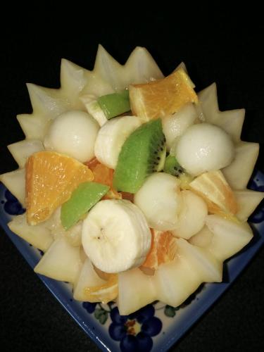 a plate of fruit with bananas oranges and other fruits at Elbhangzimmer Dresden in Dresden