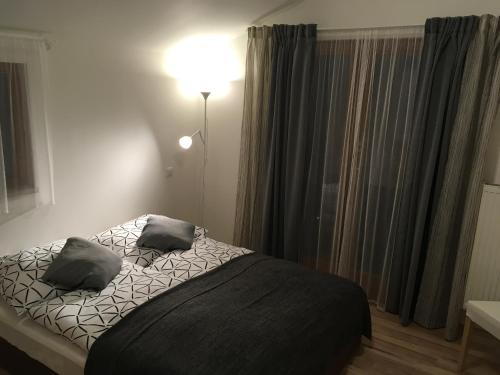 a bedroom with a bed with two pillows on it at Penzion Svatava in Ostrava