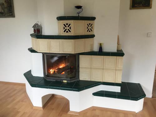 a fireplace in a living room with a stove at Penzion Svatava in Ostrava