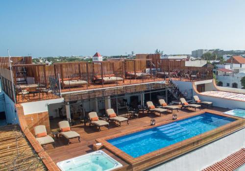 a swimming pool on the roof of a building at La Leyenda Boutique Hotel by Bunik in Playa del Carmen
