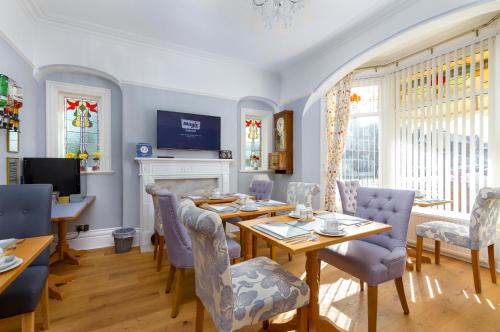 a dining room with a table and chairs at The Beechcliffe Hotel - Over 35's Only in Blackpool