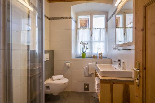 a bathroom with a toilet and a sink at Haus Haggenmüller in Hopfgarten im Brixental