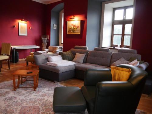 a living room with a couch and chairs and a piano at Schloss Gmünd in Gmünd