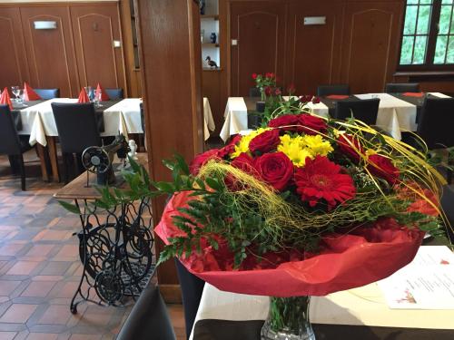 a bouquet of flowers in a vase on a table at Hotel Restaurant de l'Europe in Wissembourg