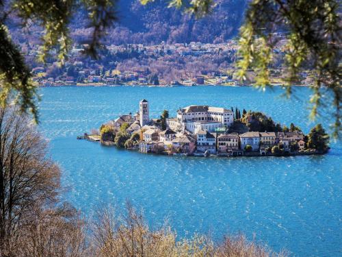 an island in the middle of a lake with houses at B&B la cruna deLago in Omegna