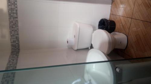 a bathroom with a toilet and a glass counter at Pousada Casa da Neuzita in Lençóis