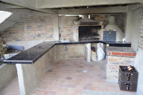 a kitchen with a counter and a brick wall at Casa Vieja Posada in Pesca