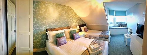 a bedroom with two beds and a wall mural at Marina Court in Weymouth