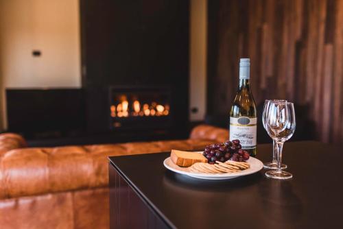 特卡波湖的住宿－特卡波湖美景公寓，一瓶葡萄酒和一盘奶酪及一杯