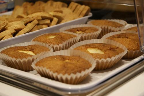 a bunch of muffins in paper cups in a display case at B&B Desenzano Paradise in Desenzano del Garda