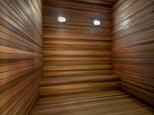 a sauna with wooden walls and two lights at Novotel Suites Ambassador Seoul Yongsan in Seoul
