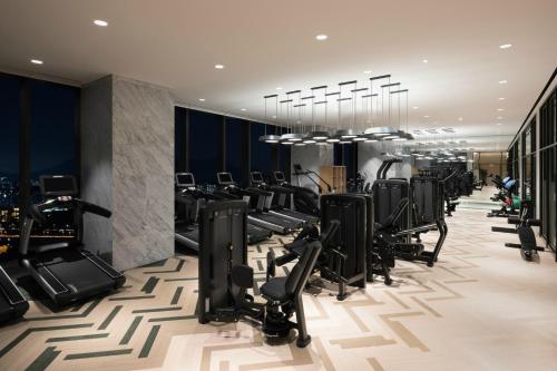 a gym with treadmills and elliptical machines at Novotel Suites Ambassador Seoul Yongsan in Seoul