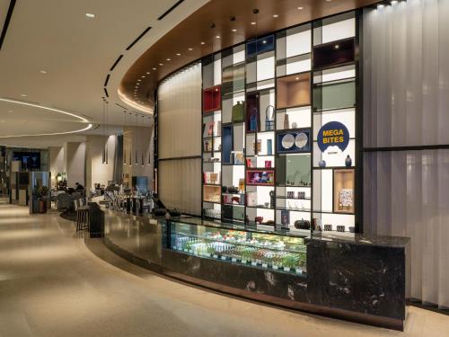 a lobby of a shopping mall with a display case at Novotel Suites Ambassador Seoul Yongsan in Seoul