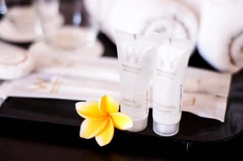 a close up of two products and a yellow flower at Wimarion Hotel Semarang in Semarang