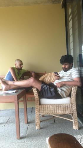 a man laying on a table with his legs on it at Homestay Namaha in Meppādi